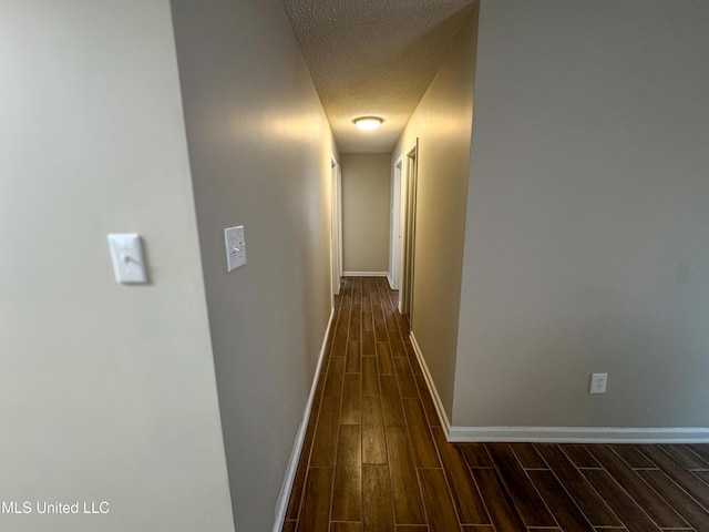 1172 Little Creek Dr, Oakland, MS 38948 - corridor featuring baseboards, a textured ceiling, and dark wood finished floors