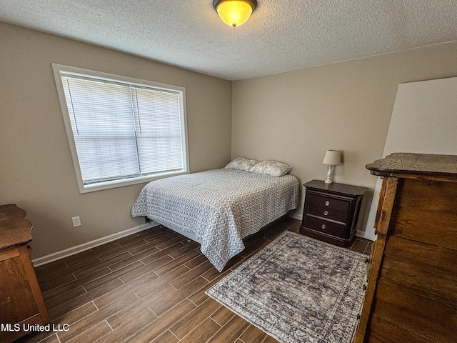 1172 Little Creek Dr, Oakland, MS 38948 - bedroom with wood tiled floor, baseboards, and a textured ceiling