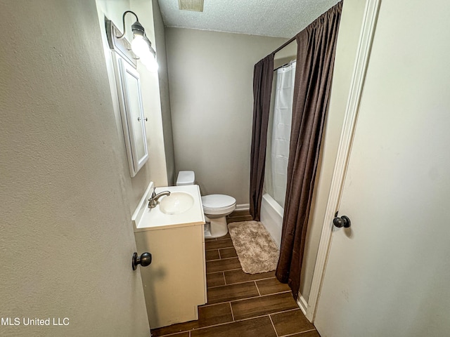 1172 Little Creek Dr, Oakland, MS 38948 - full bath featuring toilet, shower / bathtub combination with curtain, vanity, a textured ceiling, and wood finish floors