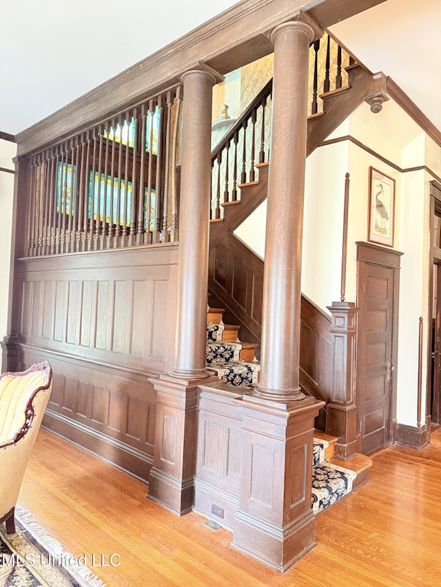 5 Spruce St, Oakland, MS 38948 - details with a wainscoted wall, wood finished floors, crown molding, and a decorative wall