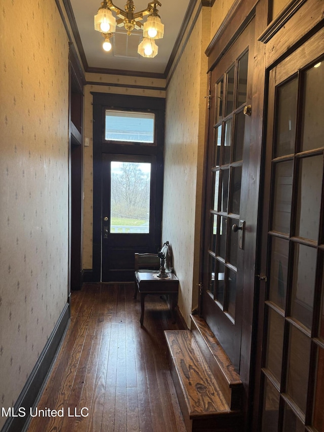 5 Spruce St, Oakland, MS 38948 - doorway to outside featuring wallpapered walls, crown molding, dark wood finished floors, and an inviting chandelier