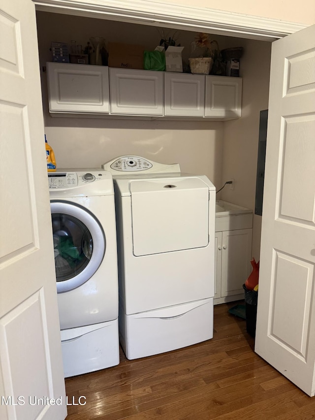 5 Spruce St, Oakland, MS 38948 - laundry room with cabinet space, independent washer and dryer, and wood finished floors