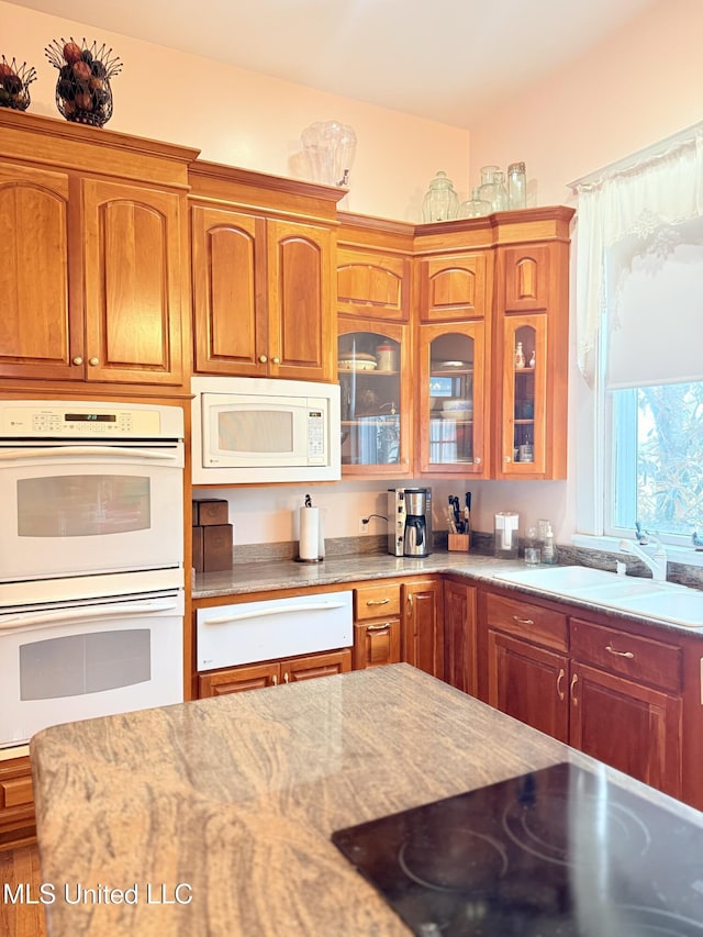 5 Spruce St, Oakland, MS 38948 - kitchen with a warming drawer, brown cabinets, a sink, white appliances, and glass insert cabinets