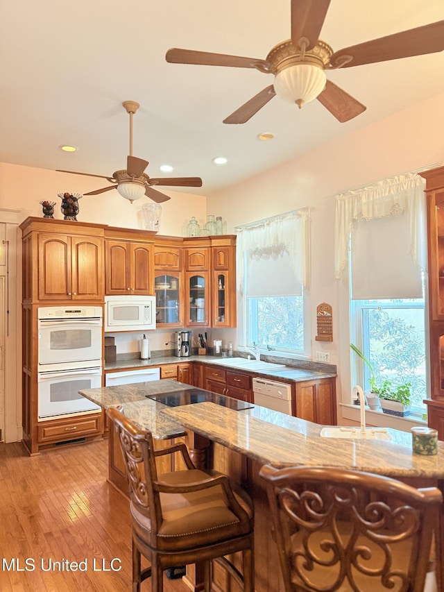 5 Spruce St, Oakland, MS 38948 - kitchen with light stone counters, brown cabinets, white appliances, and a sink