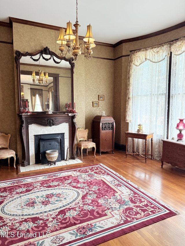 5 Spruce St, Oakland, MS 38948 - sitting room with a tiled fireplace, crown molding, a notable chandelier, and wood finished floors
