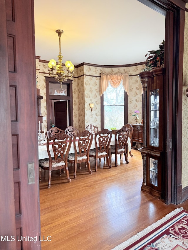 5 Spruce St, Oakland, MS 38948 - dining room with wallpapered walls, an inviting chandelier, light wood finished floors, and ornamental molding