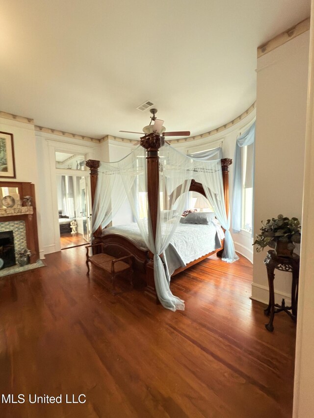 5 Spruce St, Oakland, MS 38948 - bedroom with a stone fireplace, wood finished floors, visible vents, and baseboards