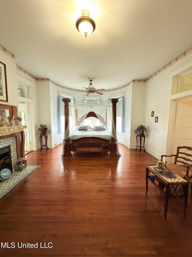 5 Spruce St, Oakland, MS 38948 - bedroom featuring baseboards, wood finished floors, and a tiled fireplace