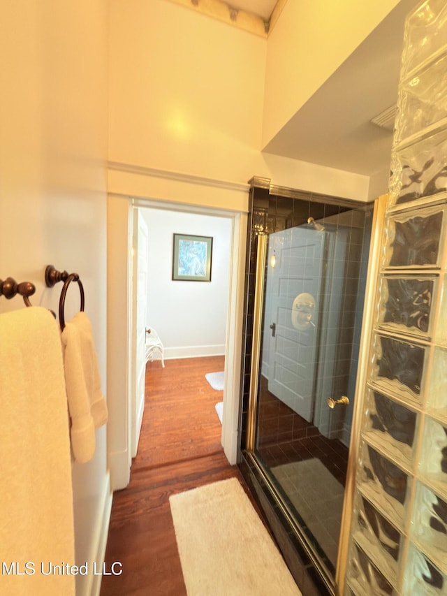 5 Spruce St, Oakland, MS 38948 - bathroom with a towering ceiling, a shower stall, baseboards, and wood finished floors