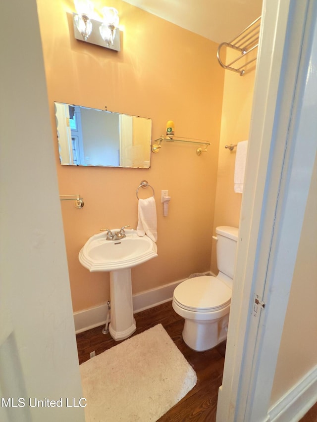 5 Spruce St, Oakland, MS 38948 - bathroom featuring a sink, toilet, baseboards, and wood finished floors