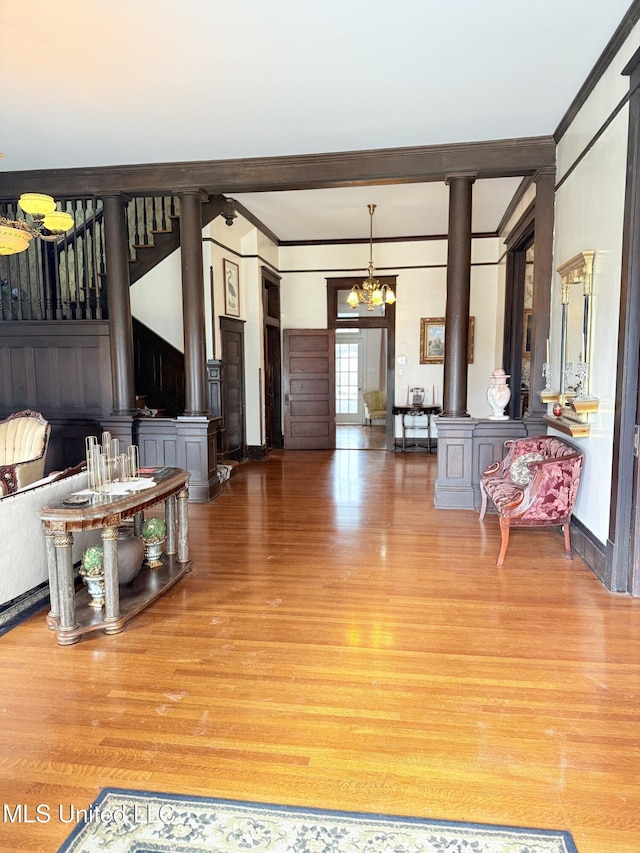 5 Spruce St, Oakland, MS 38948 - living area with a notable chandelier, wood finished floors, ornamental molding, and ornate columns