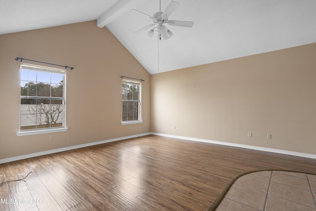 spare room with hardwood / wood-style floors, a wealth of natural light, beamed ceiling, and ceiling fan