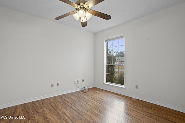 spare room featuring ceiling fan and wood-type flooring