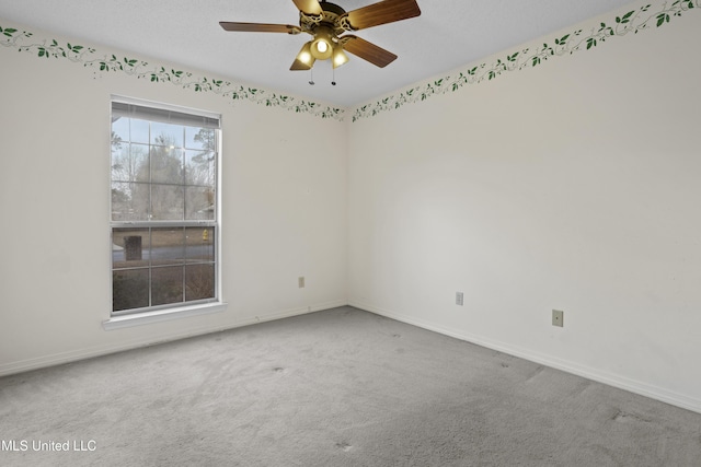 carpeted empty room featuring ceiling fan