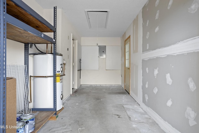 hallway with concrete flooring, gas water heater, and electric panel