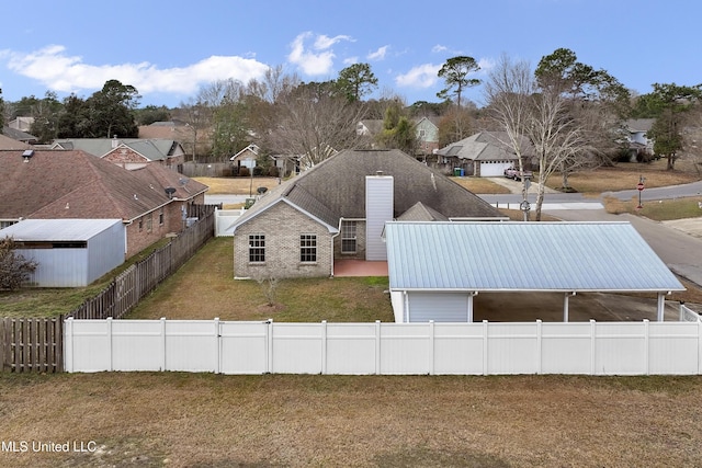 rear view of house featuring a yard