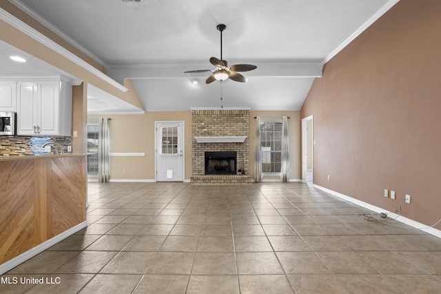 unfurnished living room featuring light tile patterned floors, vaulted ceiling, and a healthy amount of sunlight