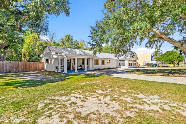 back of property featuring a patio area and a lawn