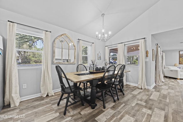 dining room with wood-type flooring, a wealth of natural light, and a chandelier