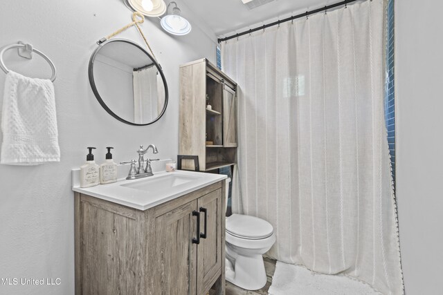 bathroom featuring vanity and toilet