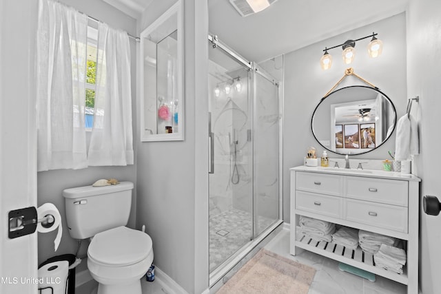 bathroom featuring a shower with door, vanity, toilet, and ceiling fan