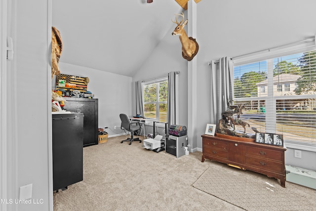 home office featuring a wealth of natural light, light colored carpet, and high vaulted ceiling