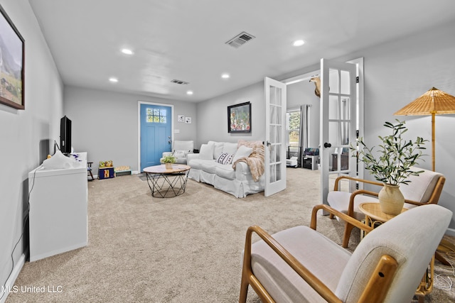 carpeted living room featuring french doors