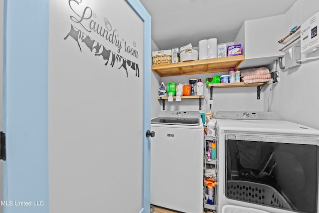 clothes washing area featuring water heater and independent washer and dryer