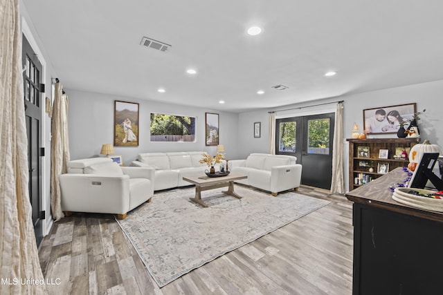 living room with hardwood / wood-style floors and french doors