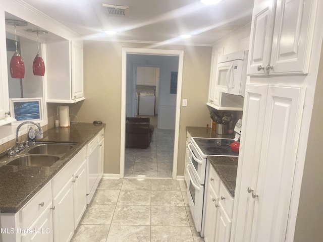 kitchen with visible vents, white appliances, a sink, and white cabinetry