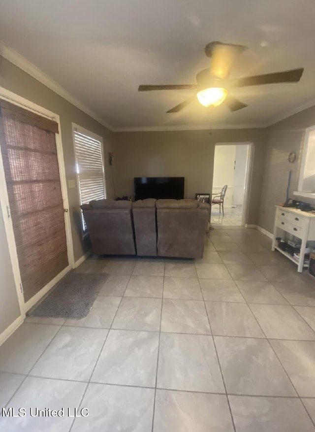 living room featuring ornamental molding, a ceiling fan, and light tile patterned floors