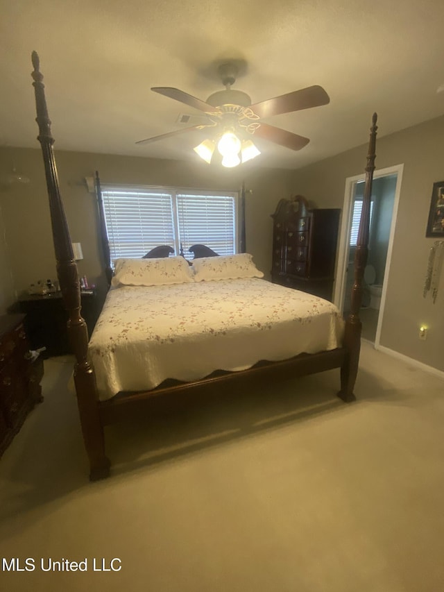 carpeted bedroom with ceiling fan and baseboards