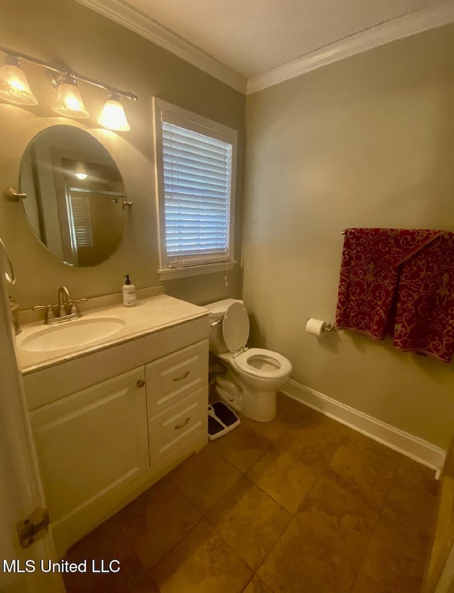 bathroom featuring toilet, a shower with shower door, vanity, baseboards, and crown molding