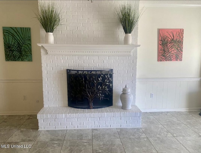 room details with wainscoting and a fireplace