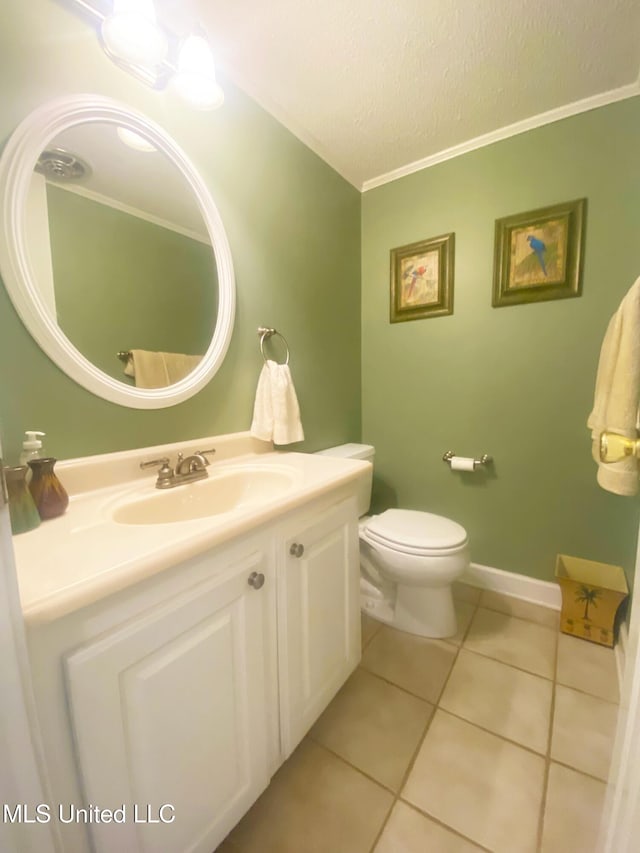 bathroom featuring a textured ceiling, toilet, vanity, baseboards, and tile patterned floors