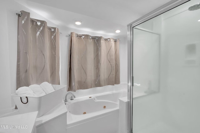 bathroom featuring separate shower and tub