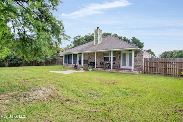 back of house with a lawn