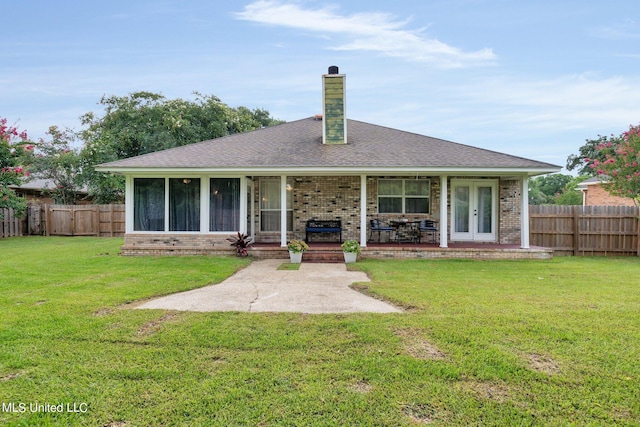 2531 Brighton Cir, Biloxi, MS 39531 - back of house with a fenced backyard, brick siding, a chimney, and a lawn