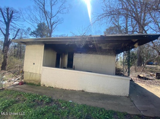 view of side of home featuring concrete block siding