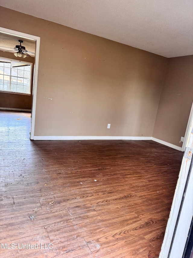 spare room with hardwood / wood-style floors, a textured ceiling, and ceiling fan