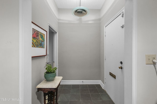 doorway featuring dark tile patterned flooring