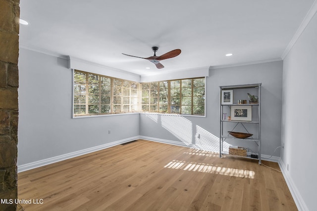 unfurnished room featuring crown molding, hardwood / wood-style flooring, and ceiling fan