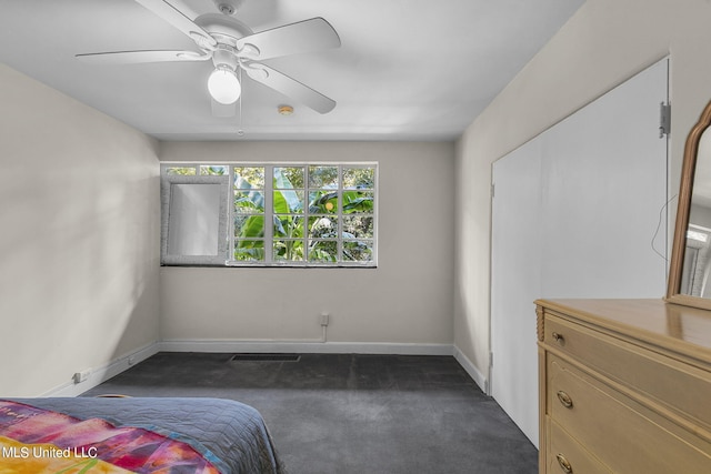 bedroom featuring ceiling fan and dark colored carpet