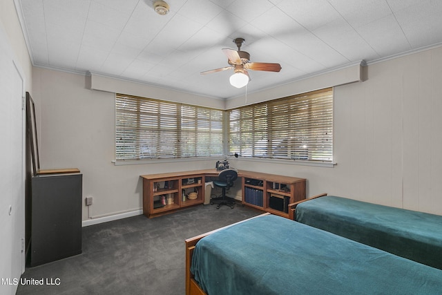 bedroom featuring ceiling fan, ornamental molding, multiple windows, and dark carpet