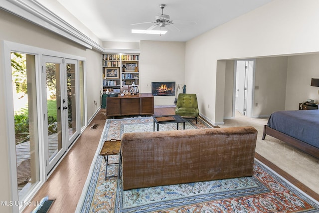 bedroom featuring lofted ceiling, hardwood / wood-style floors, ceiling fan, access to outside, and french doors