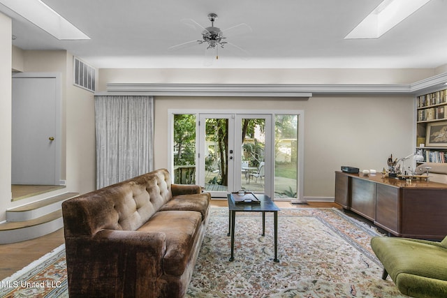 living room featuring wood-type flooring and ceiling fan