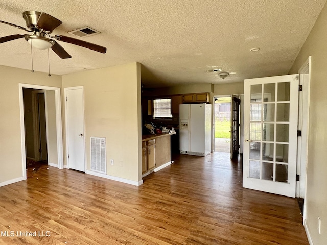 interior space with visible vents, baseboards, ceiling fan, and dark wood-style flooring