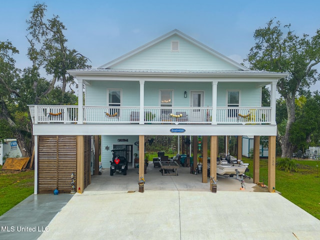 beach home with a front lawn and a carport