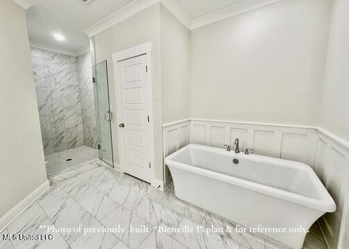 6674 Montclair Ave, Southaven, MS 38672 - bathroom with crown molding, a decorative wall, marble finish floor, a freestanding bath, and a marble finish shower