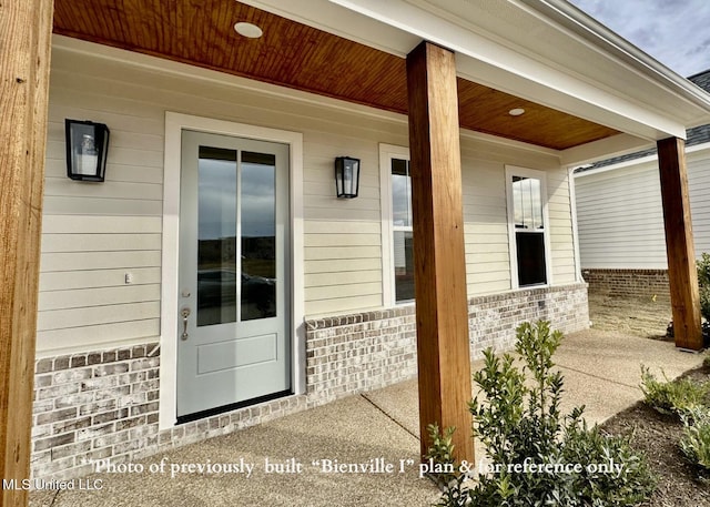 6674 Montclair Ave, Southaven, MS 38672 - doorway to property with a porch and brick siding